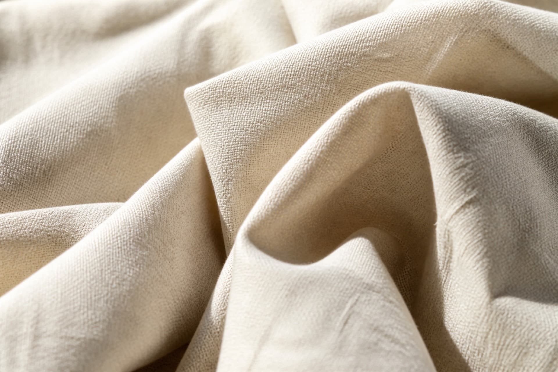 Close-up of natural linen fabric with soft folds